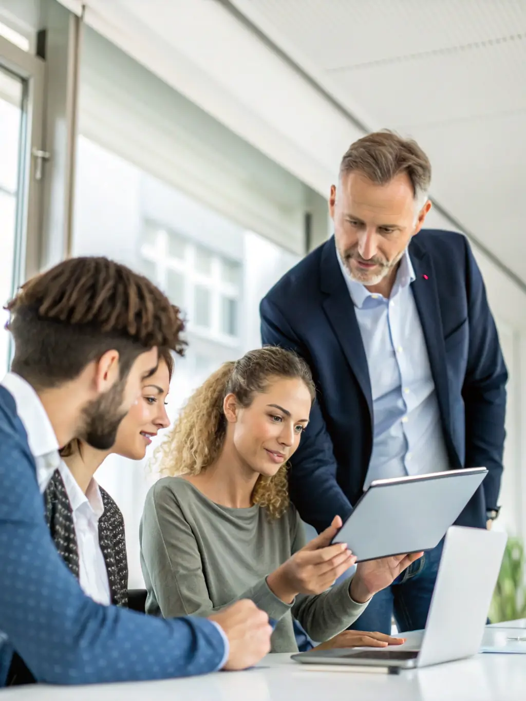 A consultant advising a business team in a modern office setting, representing Enest Solutions' IT consultancy, support, and maintenance services.